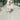 Bohemian bride in white knit wool poncho at garden ceremony